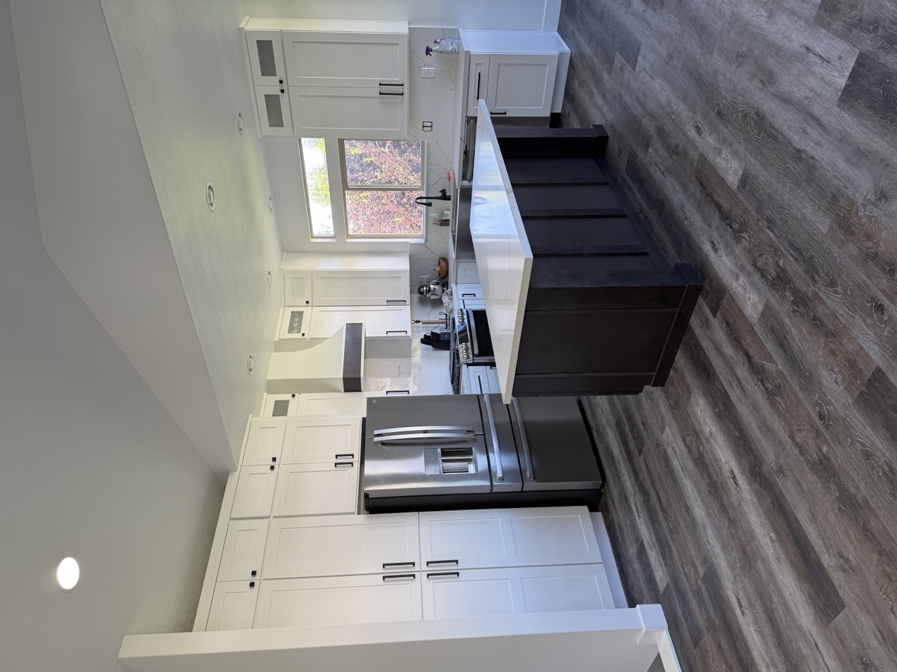 Modern white shaker kitchen with dark island - after renovation by Salt City Cabinet