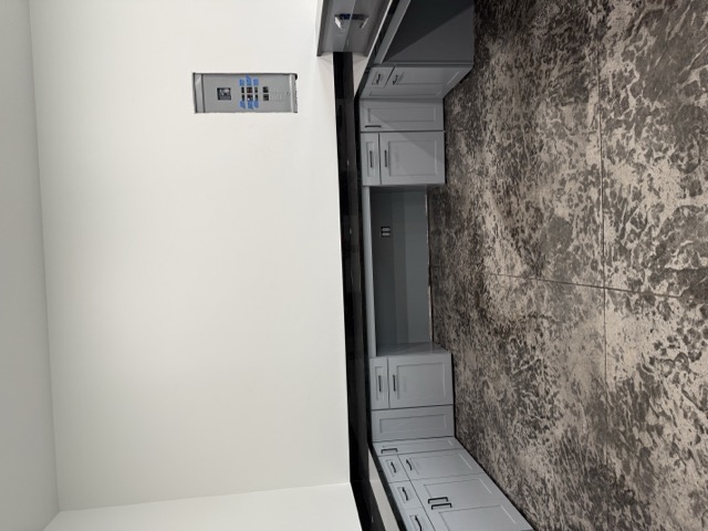 Gray shaker cabinets with dark countertop in commercial space