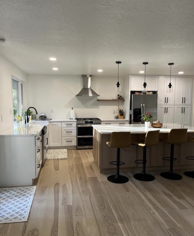 Kitchen renovation with white shaker cabinets and island